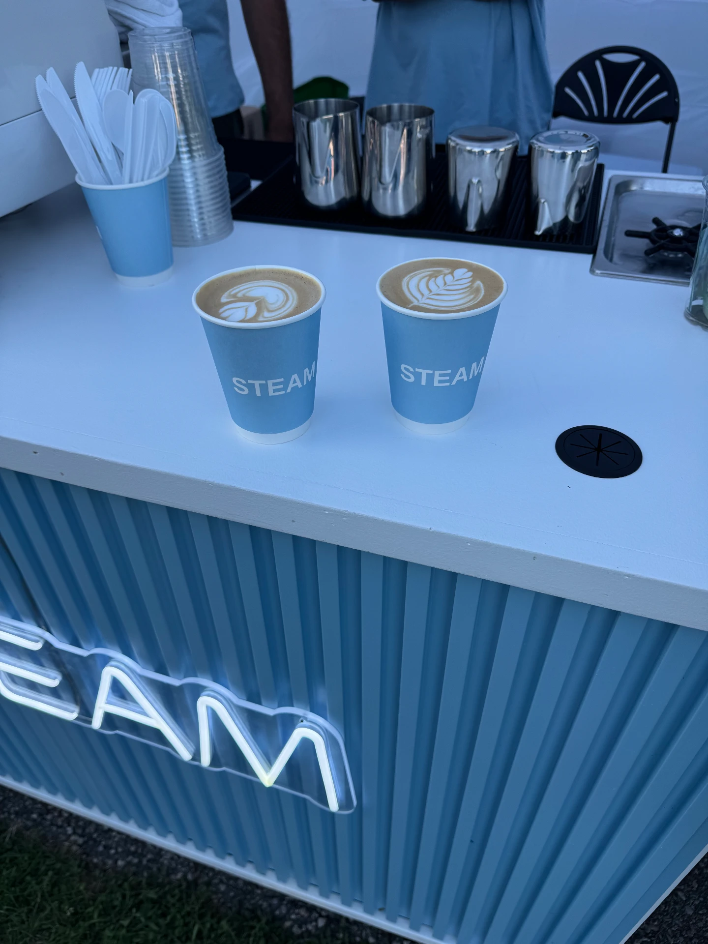 Two STEAM lattes freshly poured at the cart